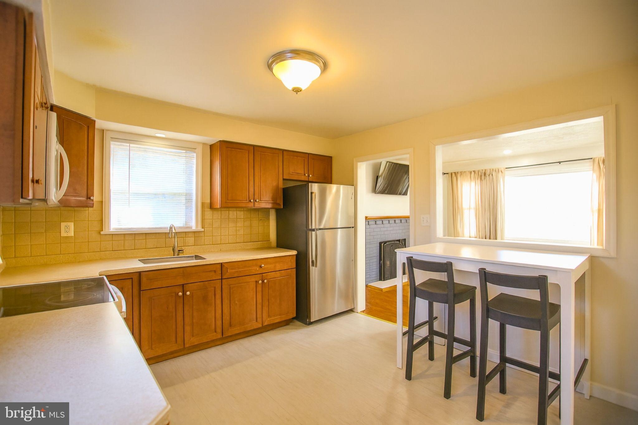 9200 Pine View Lane Clinton, MD 20735 - Photo 9 of 28 a kitchen with stainless steel appliances granite countertop a sink and a refrigerator