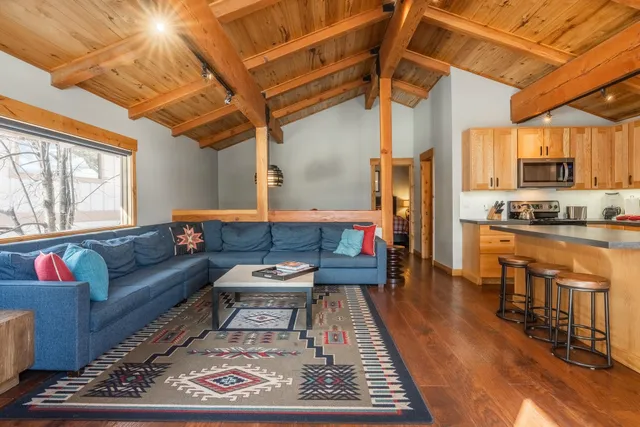 a living room with furniture a table and a fireplace