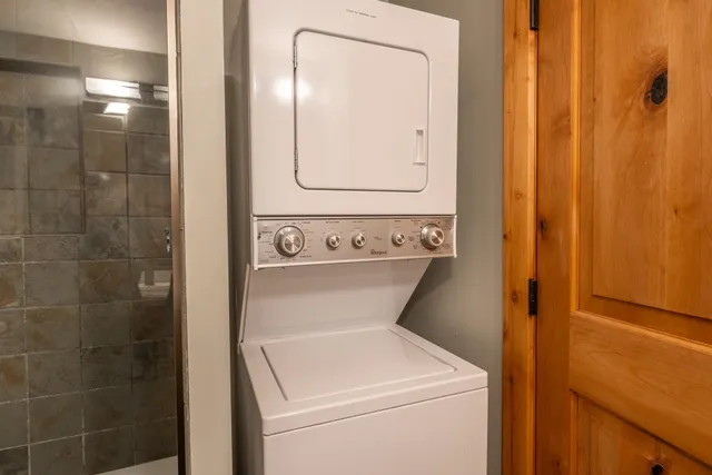 a bedroom with a bed and a flat tv screen on a table