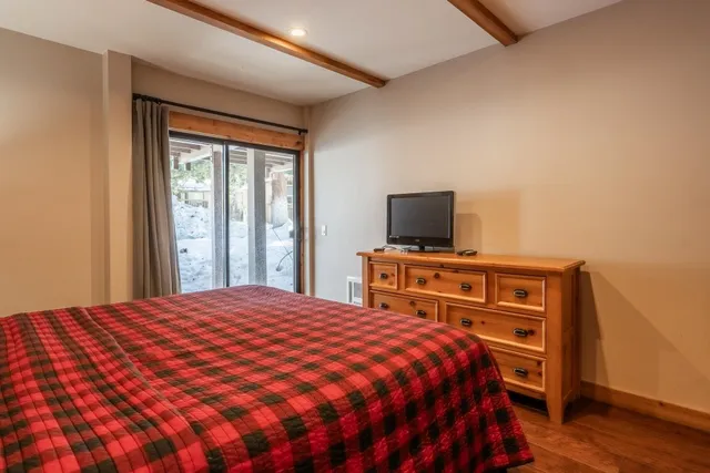 a bedroom with a bed and a flat screen tv