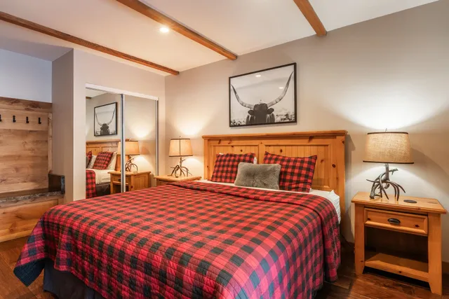 a bedroom with a bed and a mirror