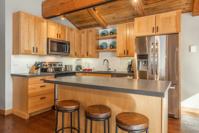 a kitchen with a table chairs sink and cabinets