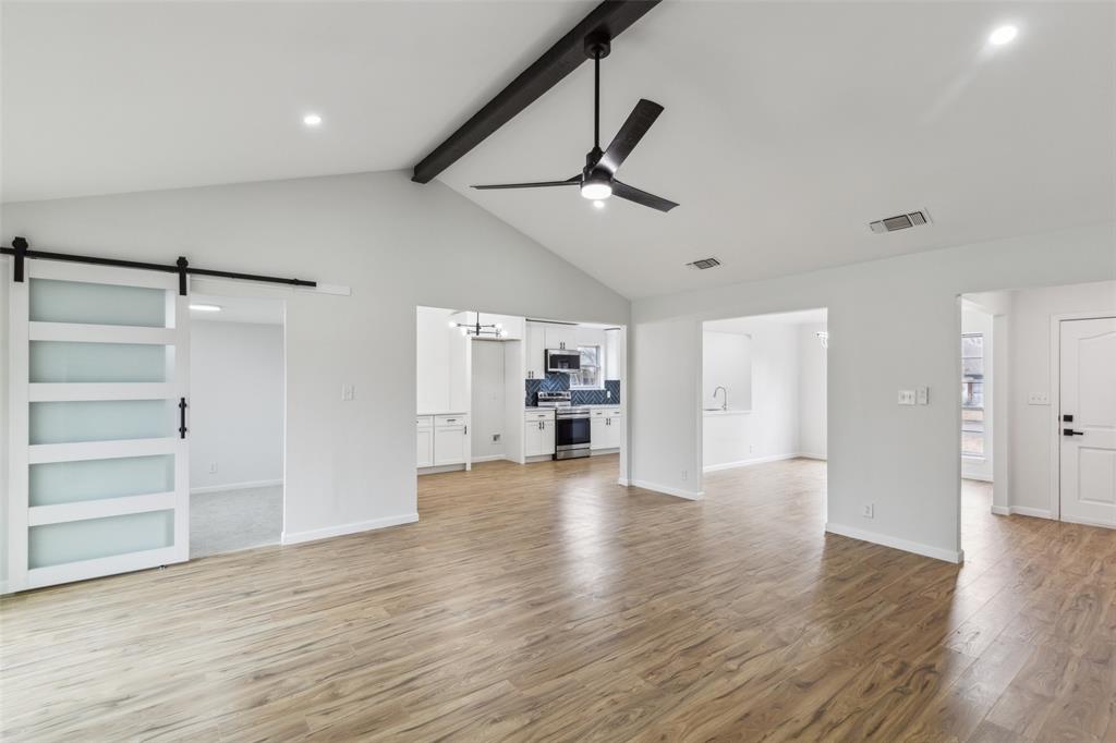 911 Pebblebrook Drive Allen, TX 75002 - Photo 6 of 32 a view of a kitchen with wooden floor and a ceiling fan