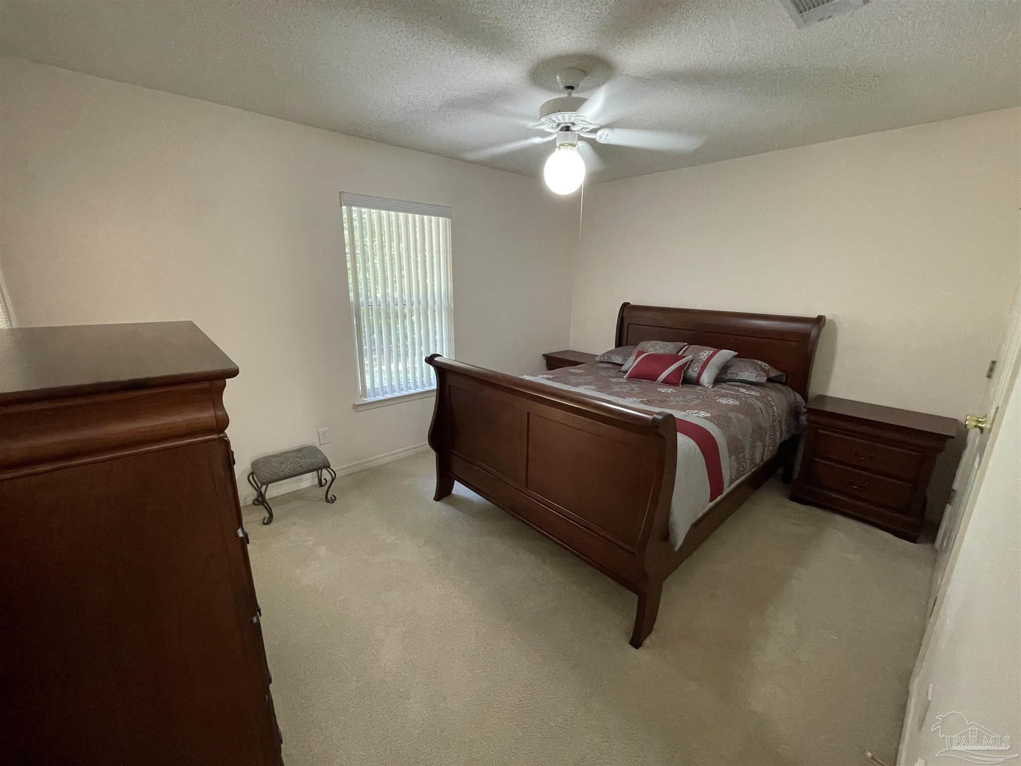 941 Spring Creek Circle Pensacola, FL 32514 - Photo 16 of 30 a bed sitting in a bedroom next to a window