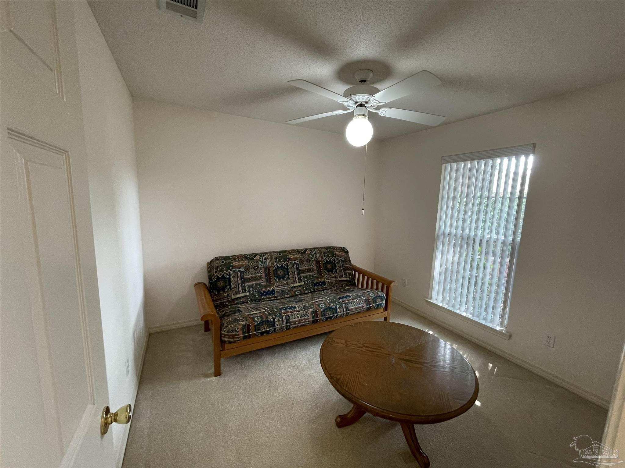 941 Spring Creek Circle Pensacola, FL 32514 - Photo 18 of 30 a living room with furniture and a chandelier