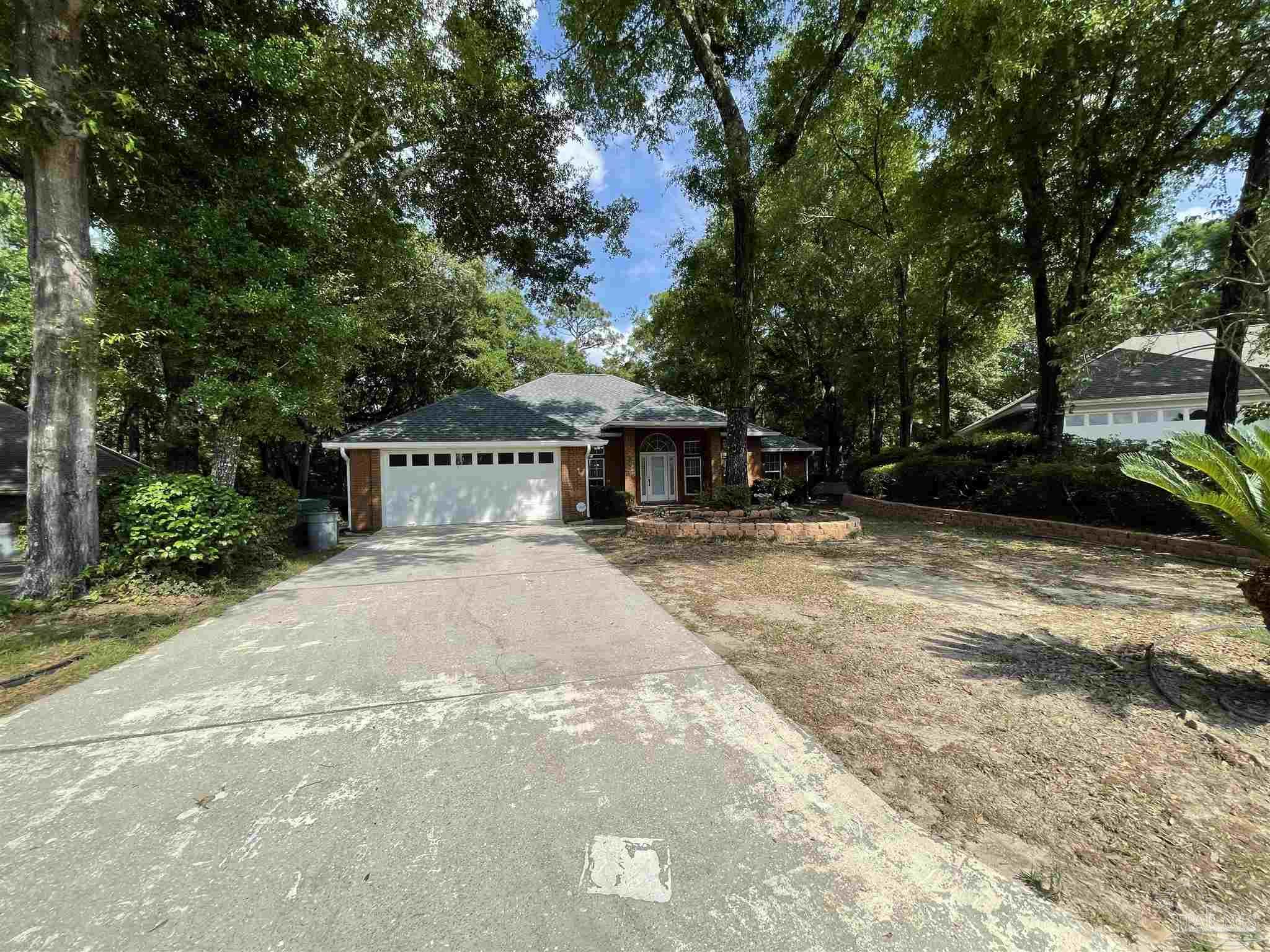 941 Spring Creek Circle Pensacola, FL 32514 - Photo 2 of 30 a house with trees in front of it