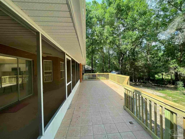 a view of a balcony with yard