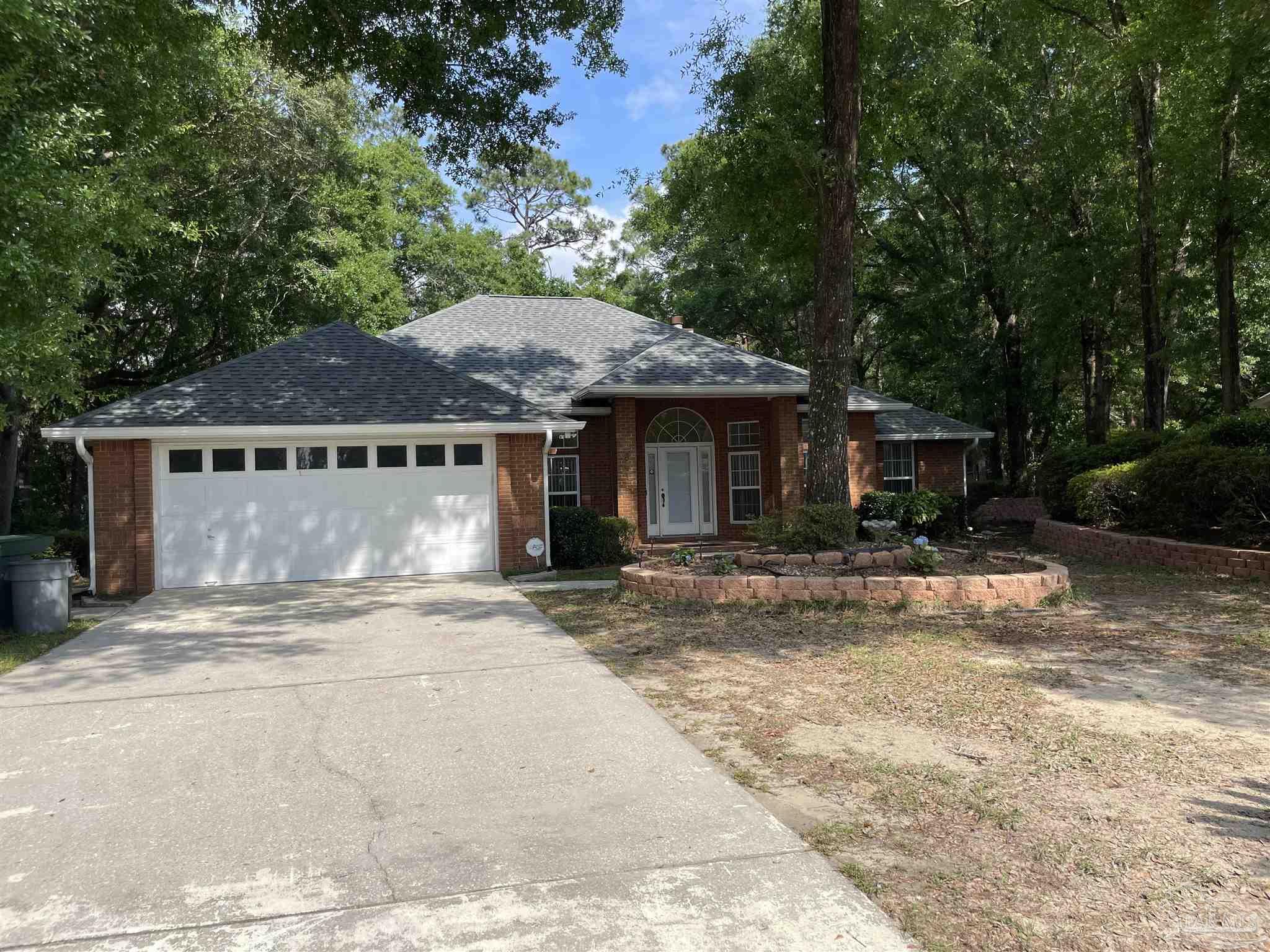 941 Spring Creek Circle Pensacola, FL 32514 - Photo 4 of 30 a front view of a house with a garden