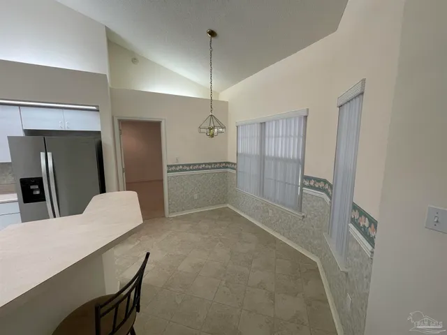 a view of kitchen and refrigerator