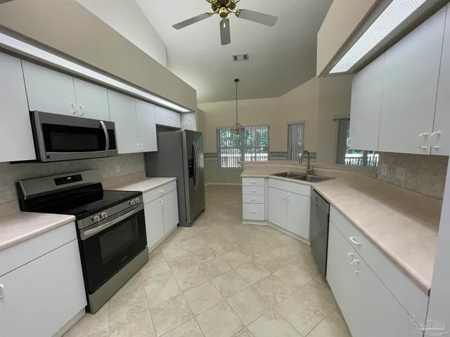 a kitchen with a sink stainless steel appliances and cabinets