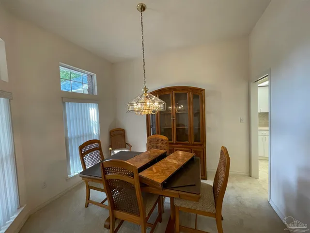 a dining room with furniture and chandelier
