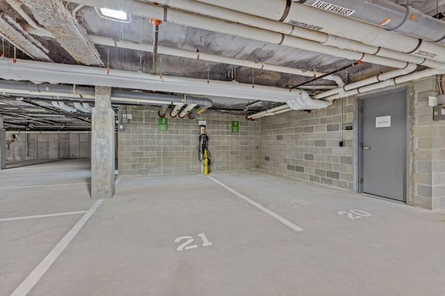 a front view of a building and car parked