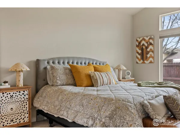 a bedroom with a bed and painting on the wall