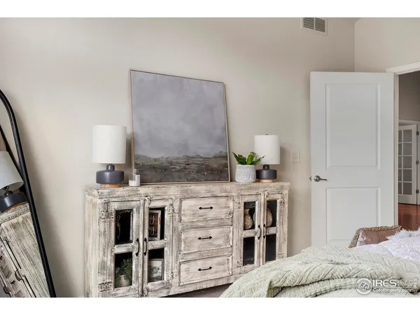 a bedroom with a bed and a dresser in it