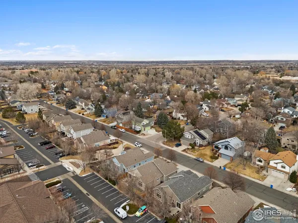 an aerial view of multiple houses with yard