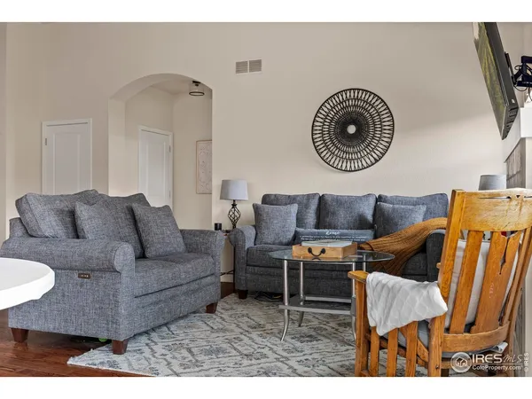 a living room with furniture and a mirror