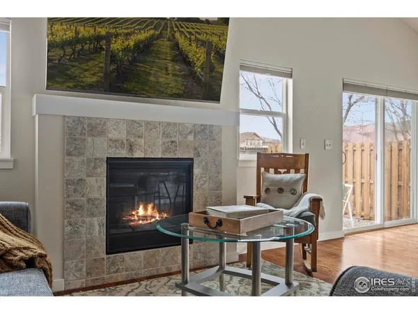 a living room with furniture a window and a fireplace