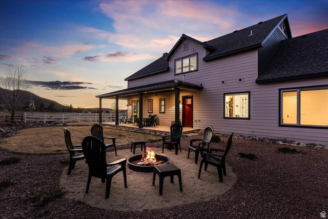 1210 East Bristle Cone Road Pine Valley, UT 84781 - Photo 39 of 54 Back of property at dusk with a patio area, roof with shingles, and a fire pit