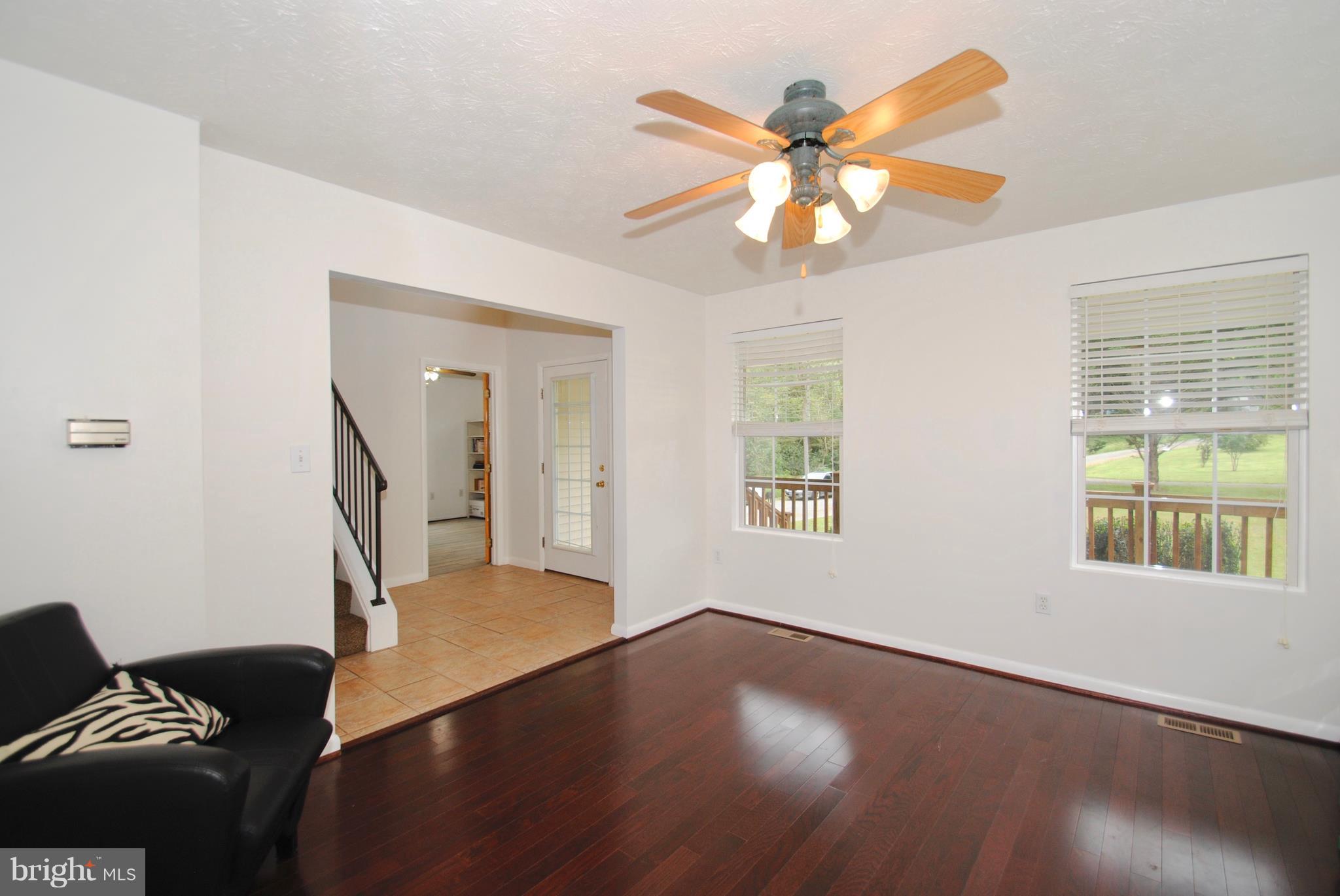 302 Fairhaven Road Tracys Landing, MD 20779 - Photo 7 of 24 a view of an empty room with wooden floor and a window