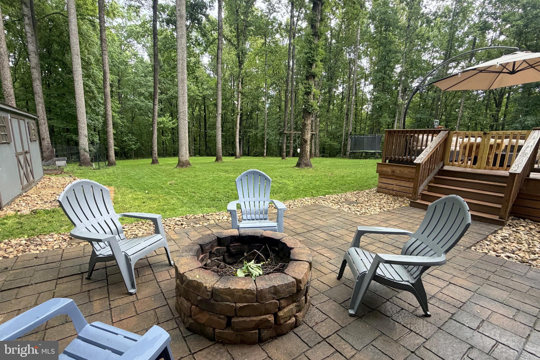 1425 Jacks Shop Road Rochelle, VA 22738 - Photo 52 of 56 a view of a patio with a table chairs and a yard