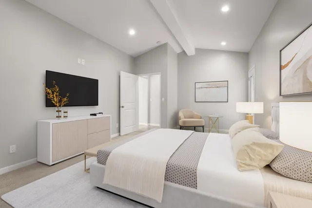 a bedroom with a bed and a flat screen tv