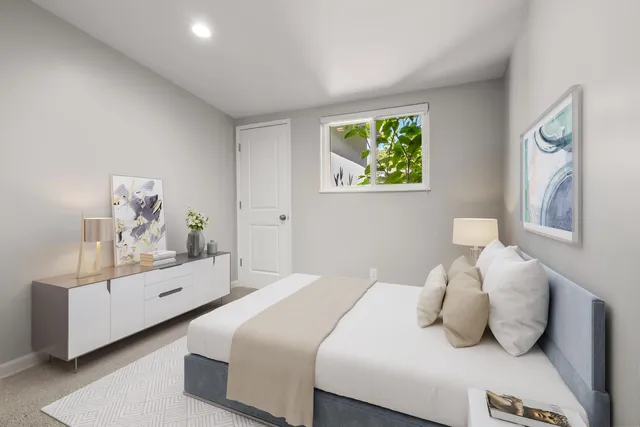 a bedroom with a bed and window