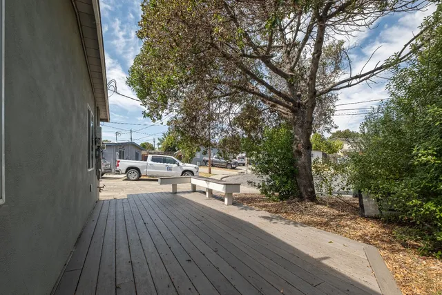 a view of balcony with wooden floor and outdoor seating