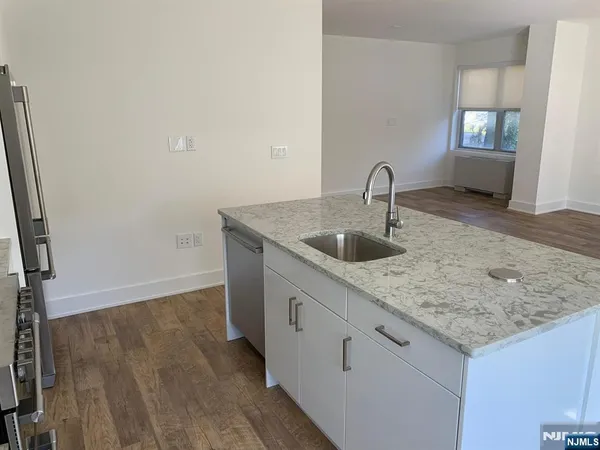 a kitchen with a sink and a hard wood floor
