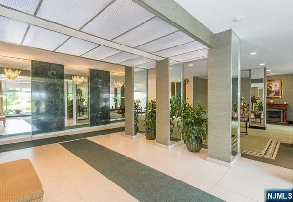 a lobby with furniture and floor to ceiling window