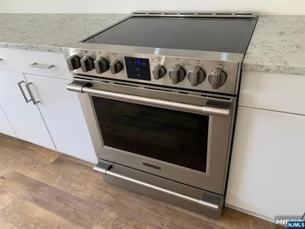 a stove top oven sitting inside of a kitchen
