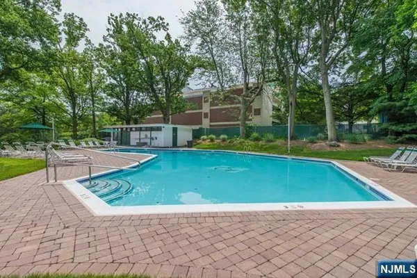 a view of a backyard with swimming pool
