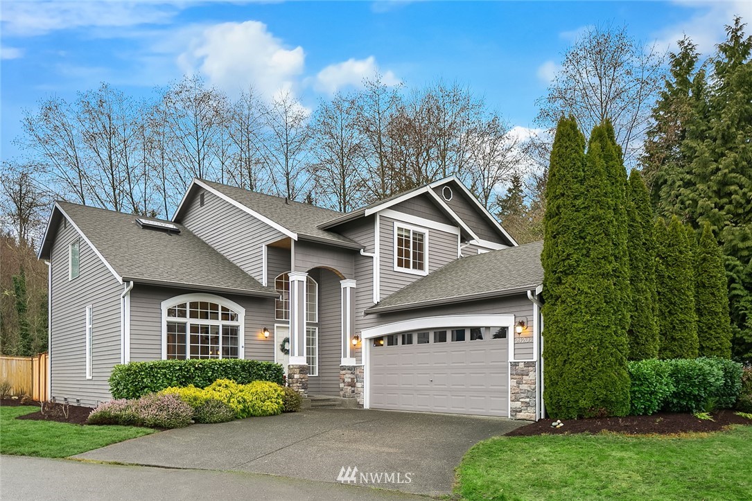 24204 18th Place West Bothell, WA 98021 - Photo 1 of 28 a front view of a house with a garden