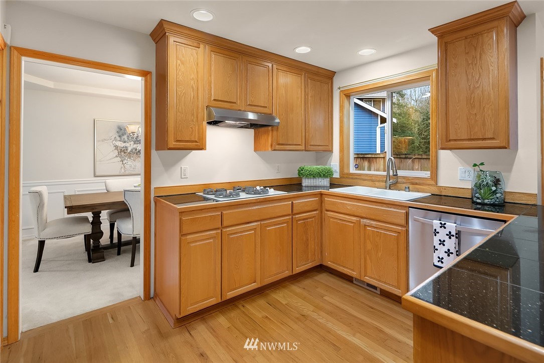 24204 18th Place West Bothell, WA 98021 - Photo 13 of 28 a kitchen with stainless steel appliances granite countertop a sink stove and cabinets