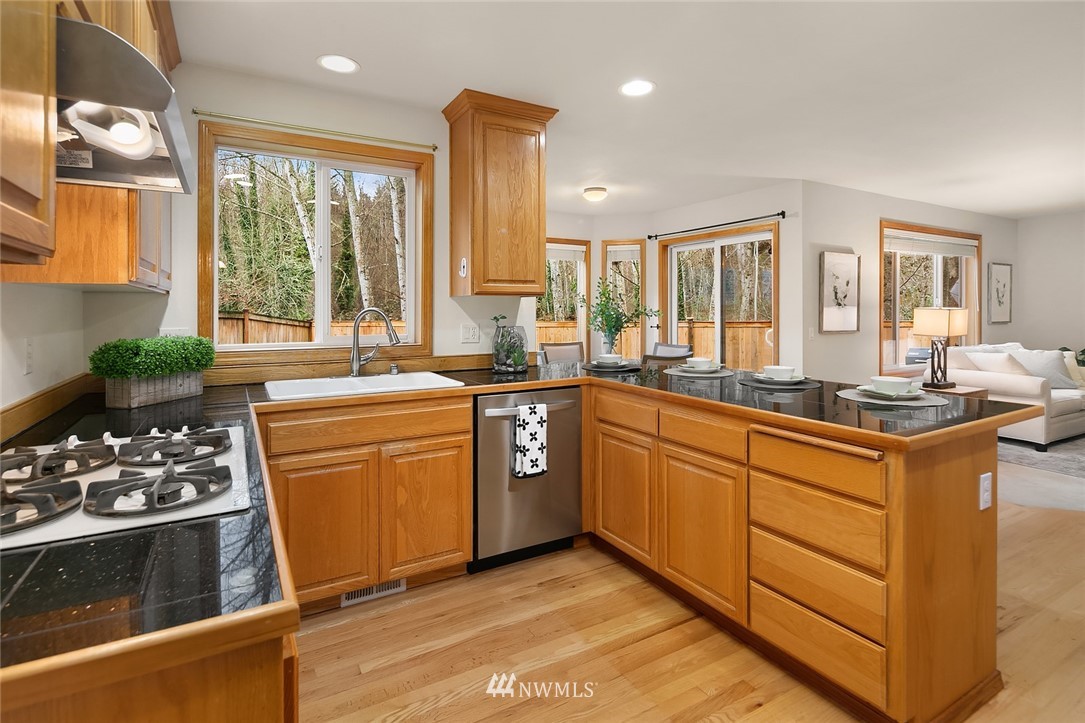 24204 18th Place West Bothell, WA 98021 - Photo 14 of 28 a kitchen with stainless steel appliances sink stove and refrigerator