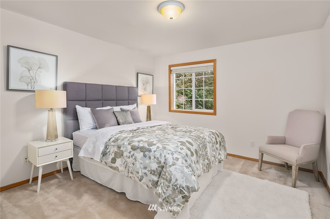 24204 18th Place West Bothell, WA 98021 - Photo 22 of 28 a bedroom with a bed and chair