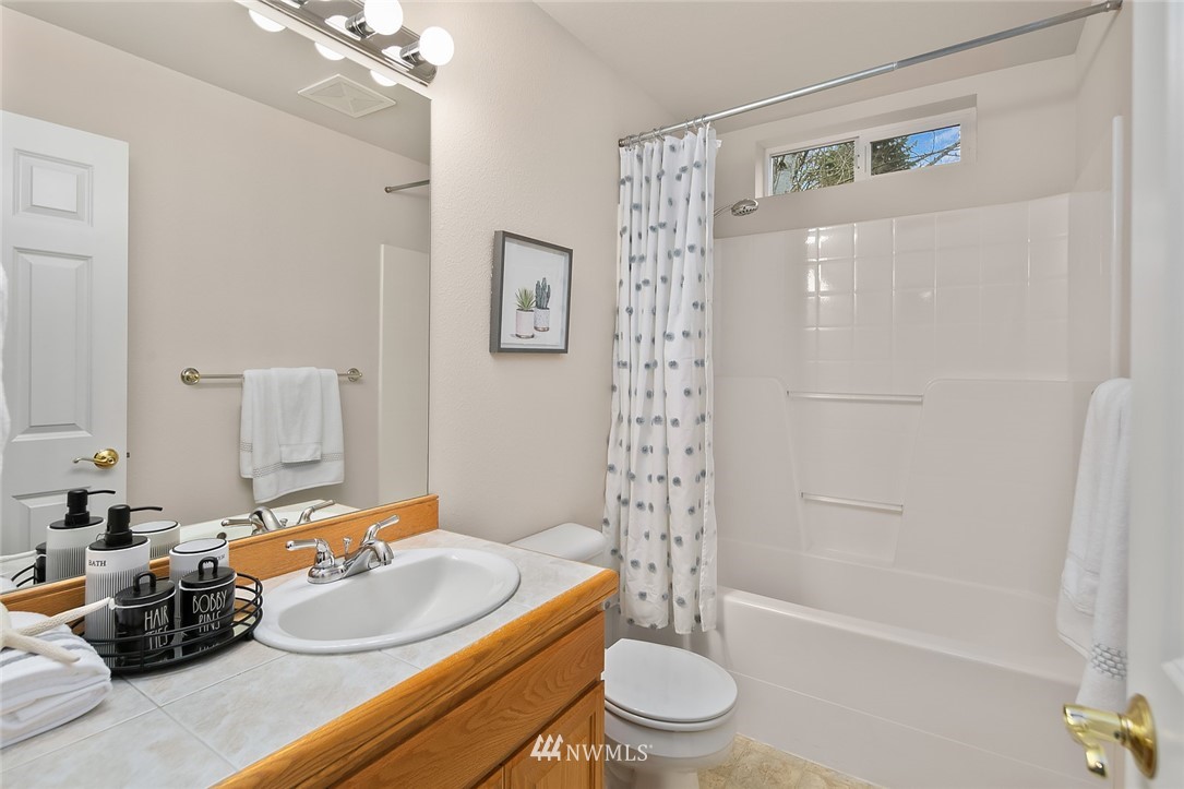 24204 18th Place West Bothell, WA 98021 - Photo 25 of 28 a bathroom with a sink a toilet and shower