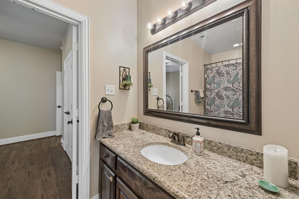 8104 Red Riv Run North Richland Hills, TX 76180 - Photo 20 of 38 a bathroom with a granite countertop double vanity sink and a mirror