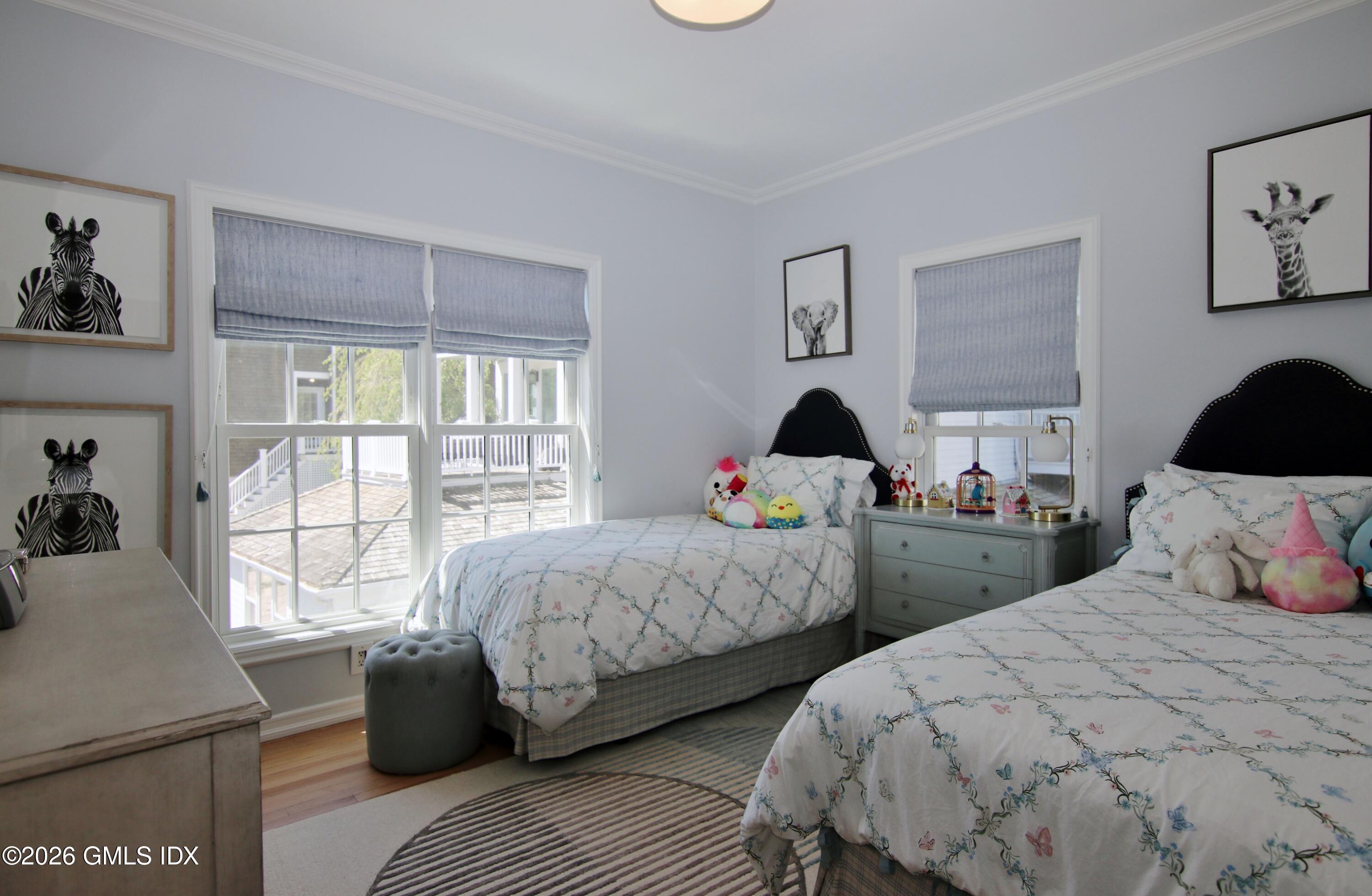 633 Steamboat Road, Unit 5 Greenwich, CT 06830 - Photo 10 of 29 a bedroom with two beds and a window