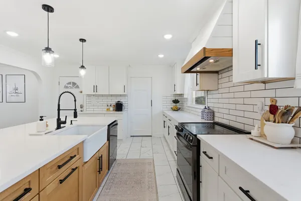 a kitchen with stainless steel appliances a sink stove and refrigerator