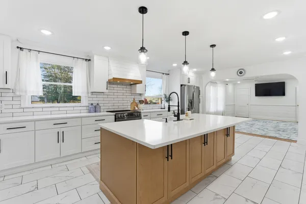 a kitchen with counter top space appliances and a sink