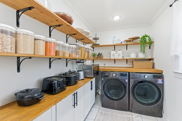 a utility room with sink dryer and washer