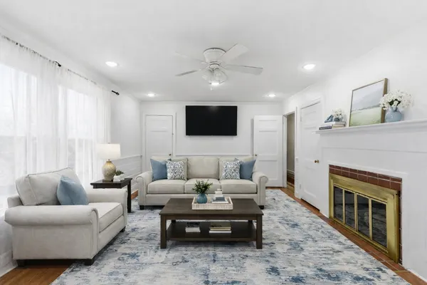 a living room with furniture a fireplace and a flat screen tv