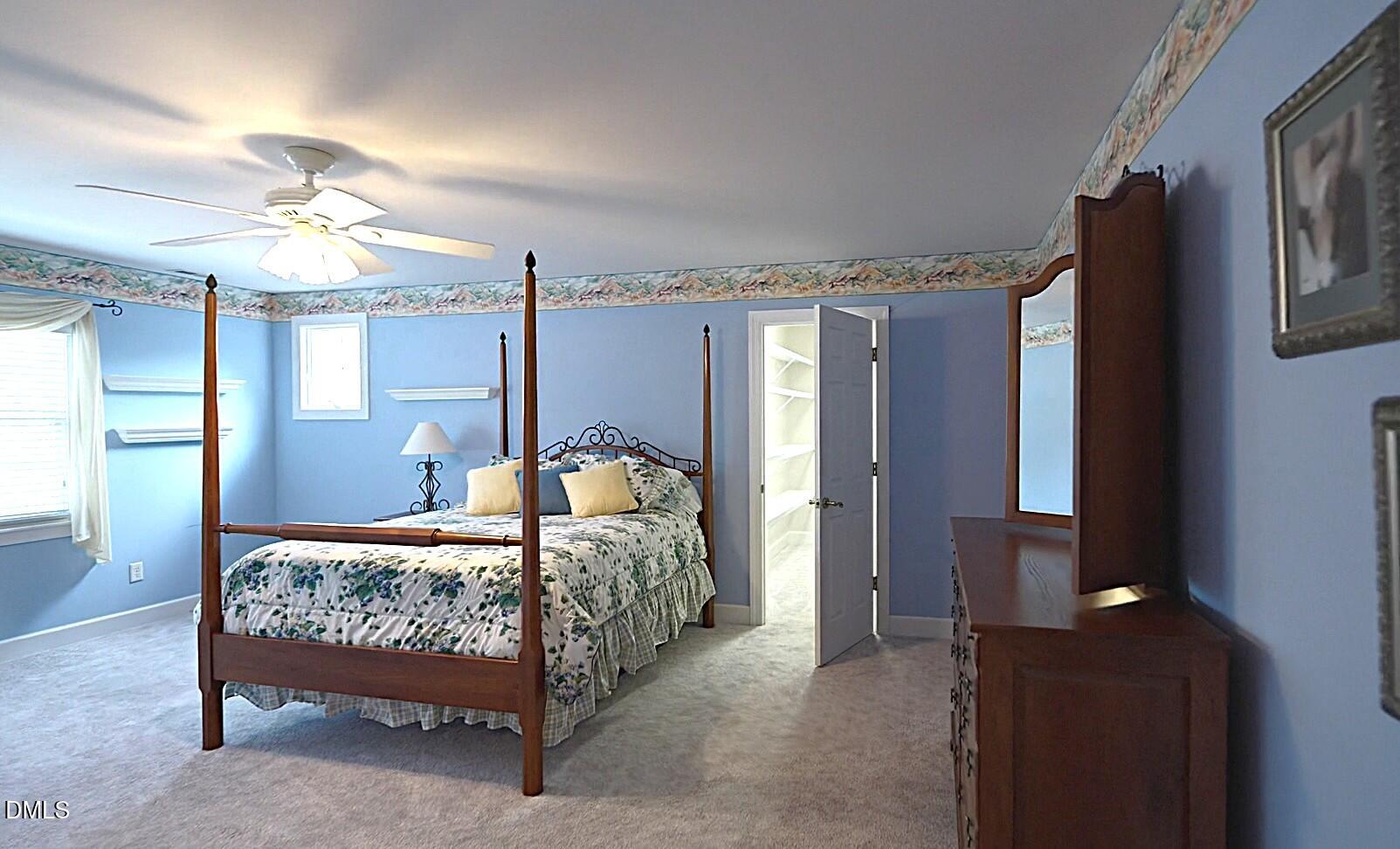 220 Jordan Narron Road Selma, NC 27576 - Photo 48 of 87 a bed room with a bed and a chandelier