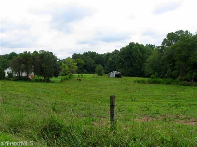 208 Collins Road Madison, NC 27025 - Photo 1 of 16 Exterior Front. View from gravel road leading down to this mini-farm.