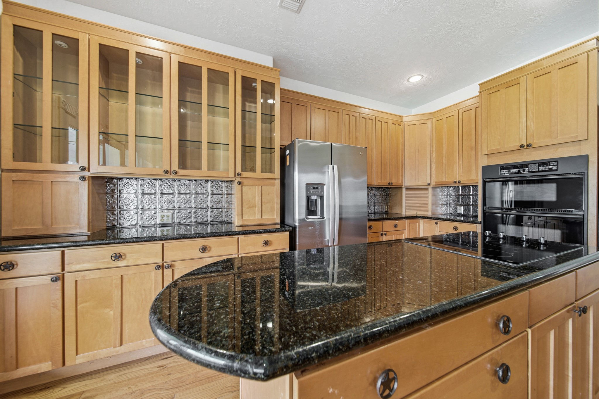 41712 Harpers Church Road Hempstead, TX 77445 - Photo 23 of 50 Kitchen number 1 w/granite countertops, ample workspace and storage, ornate tin backsplash, upgraded appliances, cabinets w/display lighting