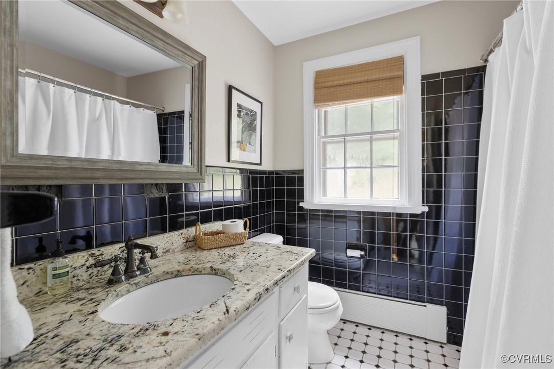4233 Waumsetta Road Richmond, VA 23235 - Photo 13 of 32 a bathroom with a granite countertop sink a toilet a mirror and shower