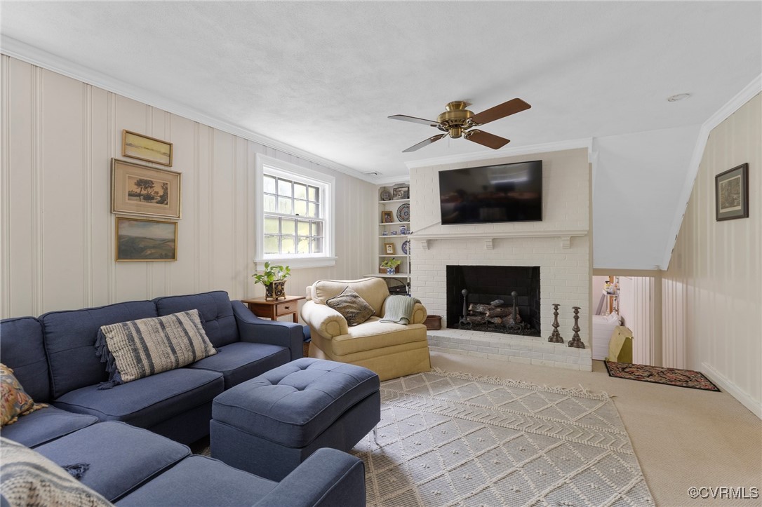 4233 Waumsetta Road Richmond, VA 23235 - Photo 15 of 32 a living room with furniture a flat screen tv and a fireplace
