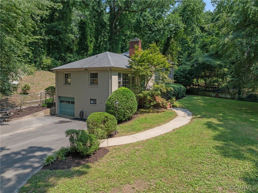 4233 Waumsetta Road Richmond, VA 23235 - Photo 23 of 32 a front view of a house with garden