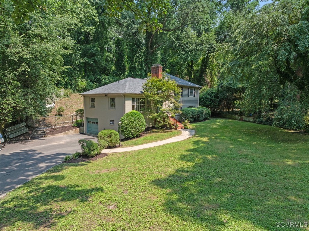 4233 Waumsetta Road Richmond, VA 23235 - Photo 24 of 32 a view of a house with a big yard plants and large trees