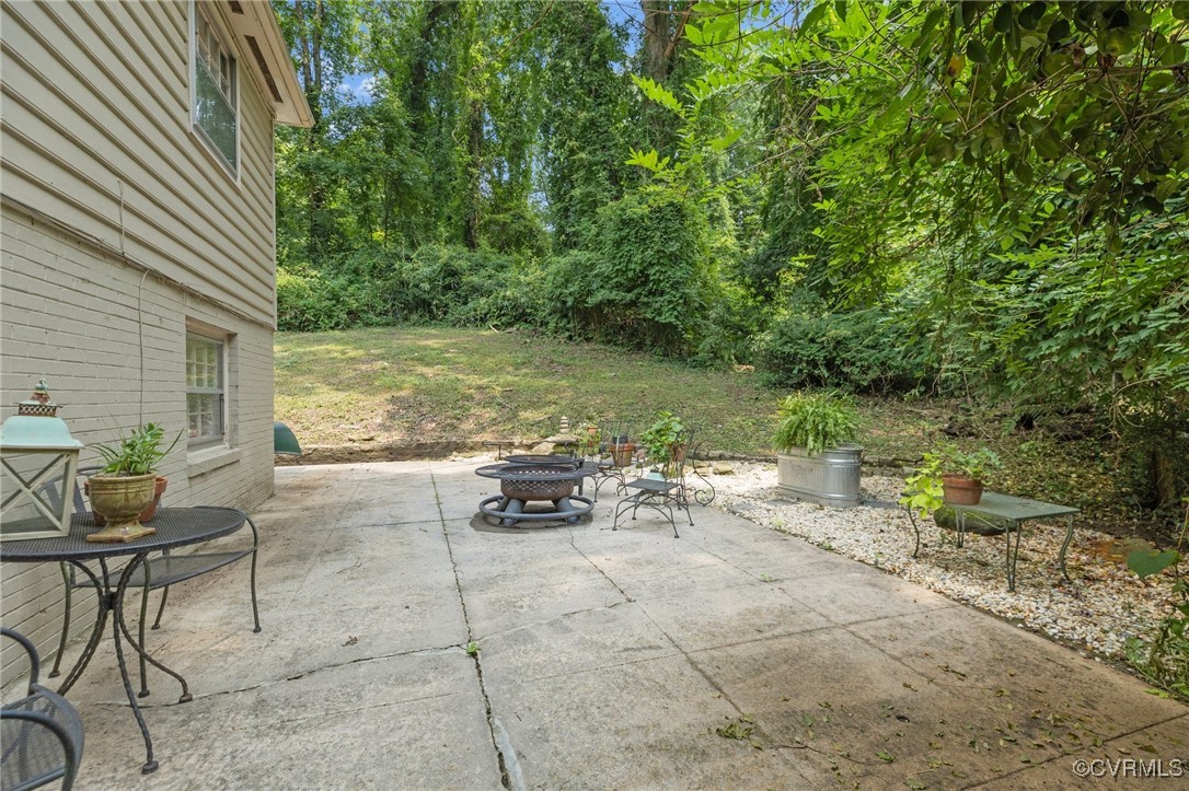 4233 Waumsetta Road Richmond, VA 23235 - Photo 31 of 32 a view of a backyard with table and chairs under an umbrella